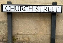 White street sign that reads Church street