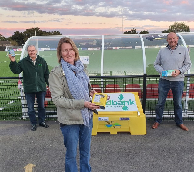 Cllr Sarah Rouse, Leader of Malvern Hills District Council, promotes the new foodbank collection point at Malvern Town FC with Peter Buchanan, Chair of Malvern Hills Foodbank and Simon Secretan, Chair of Leigh & Bransford Badgers FC.