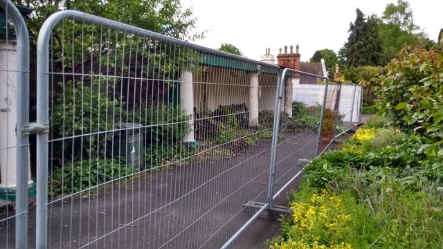 Pictured of covered seating areas with metal barriers in front  