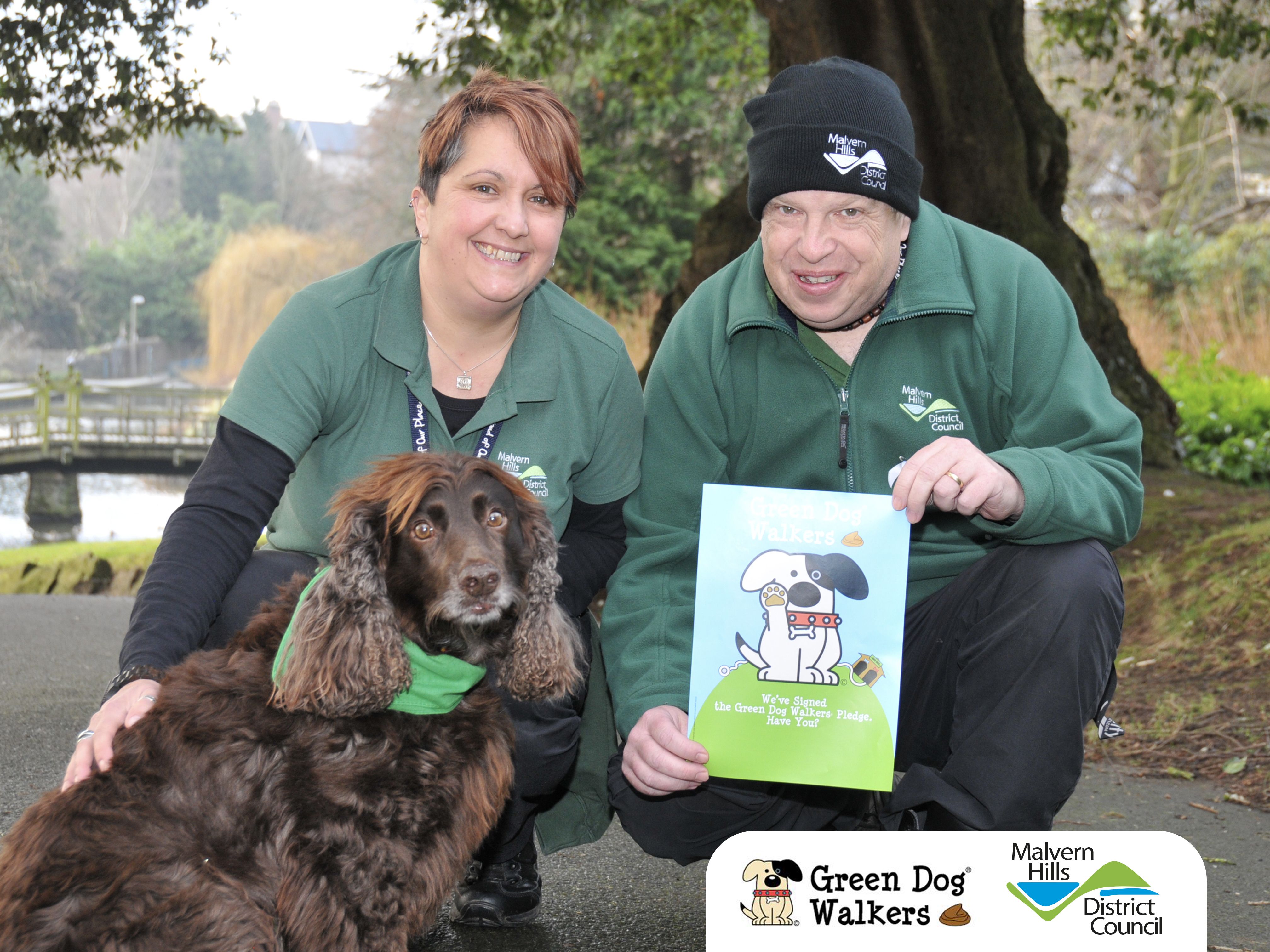 Man and Woman council workers posing with dog to promote campaign